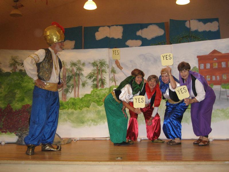 S0013_0013.jpg - The vote is in 
The Genie Master is played by Hilary Jones. The Instructors are Marsha Sweeney, Janice Monkowski, Pam Grove, and Bobby Jensen. In the play, there is actually a fifth instructor, played by Bill Leach.