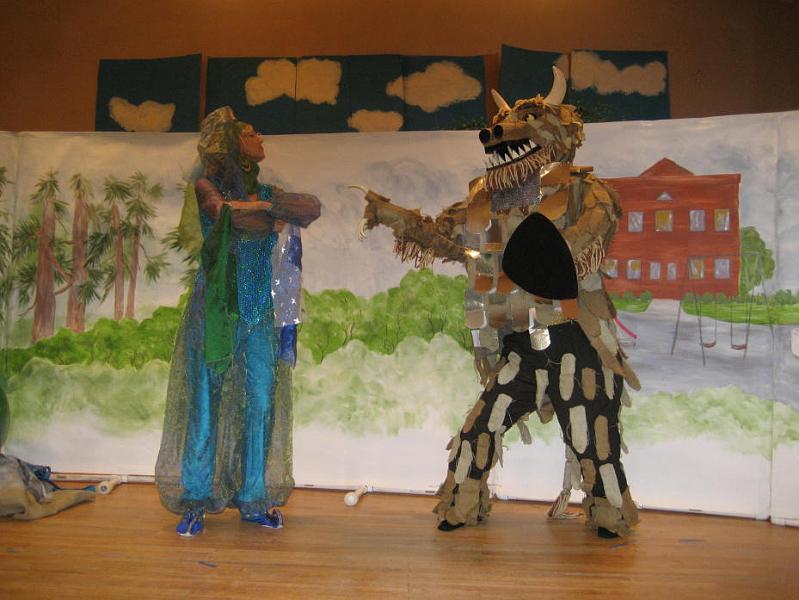 S0013_0018.jpg - Beast threatens 
Genie Reena steps in to protect the children. The beast who is assigned to protect the castle is mad at her because she gave his castle to one of the children.